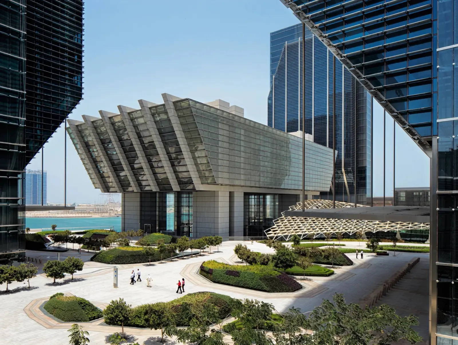Modern waterfront office building beside a landscaped plaza