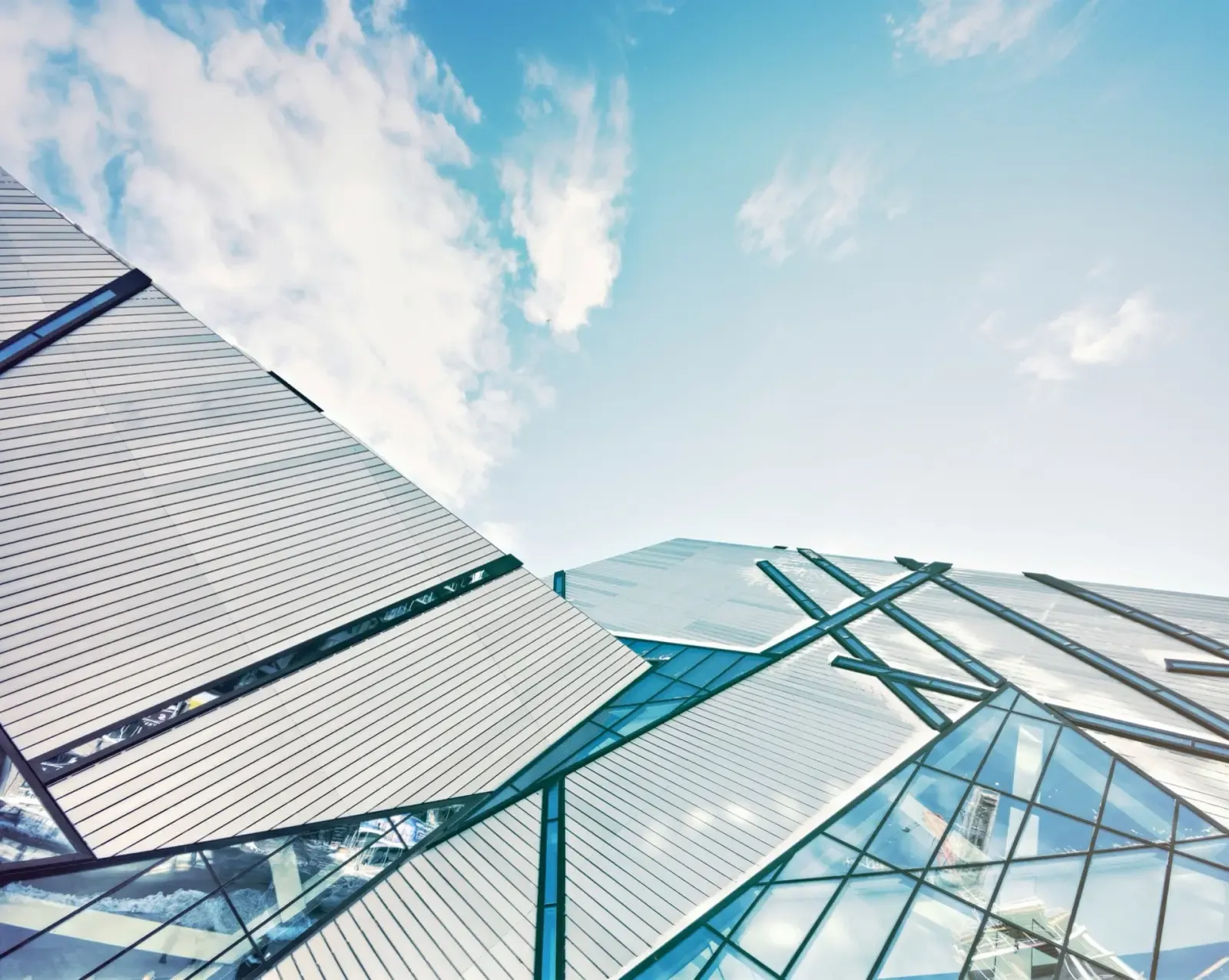 Angular glass building facade against a blue sky